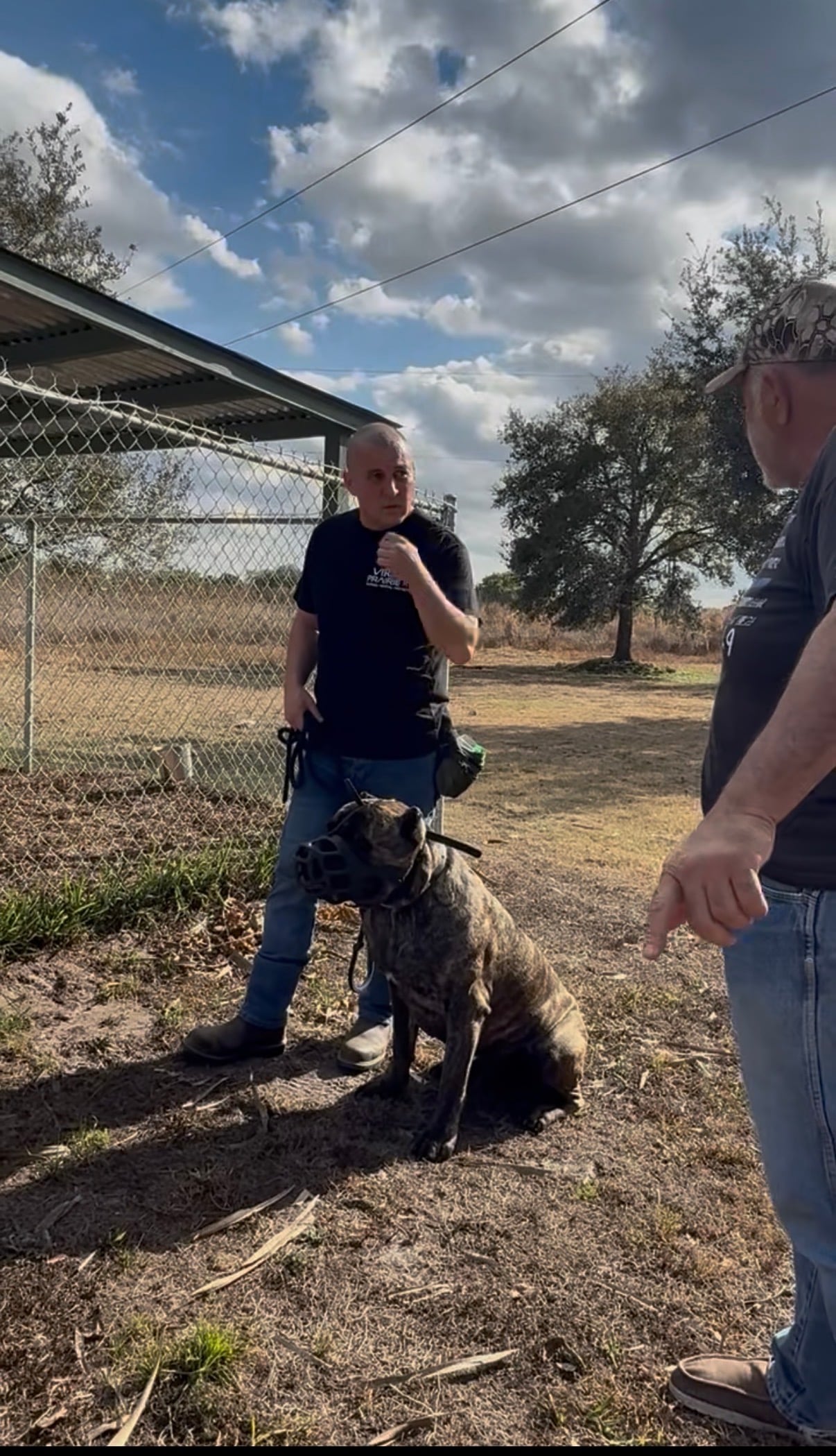 Robert and a Cane Corso outside under a big sky